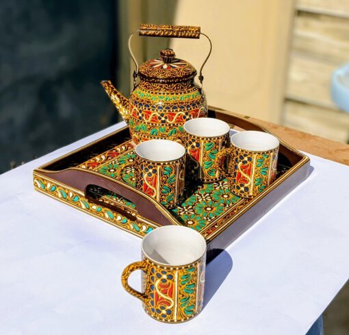 Swati art hand painted teaset. 1 tray 12 by 12 inches made of wood. 1 teapot made of steel. 4 cups made of ceramic.